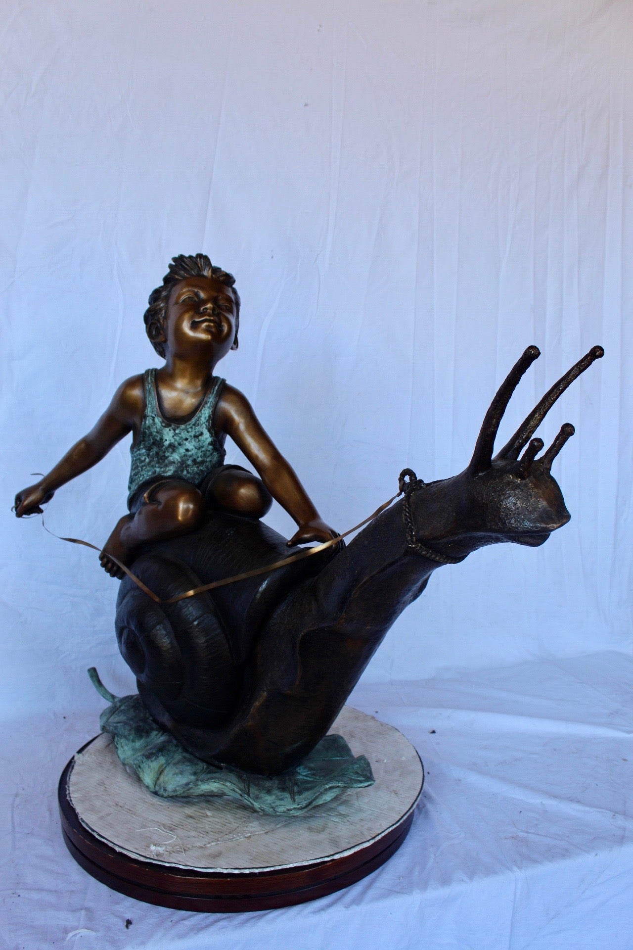 Happy boy riding a snail bronze statue fountain -  Size: 42"L x 14"W x 34"H.