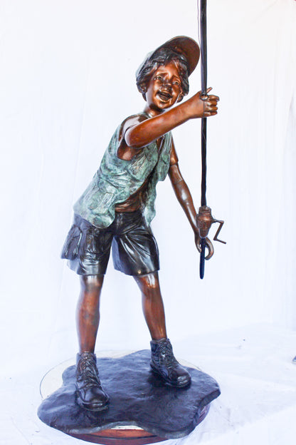 A young boy and his fishing journey bronze statue -  Size: 24"L x 26"W x 47"H.