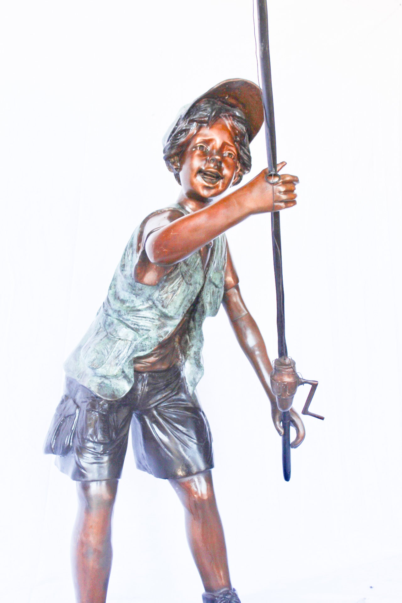 A young boy and his fishing journey bronze statue -  Size: 24"L x 26"W x 47"H.
