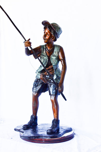 A young boy and his fishing journey bronze statue -  Size: 24"L x 26"W x 47"H.