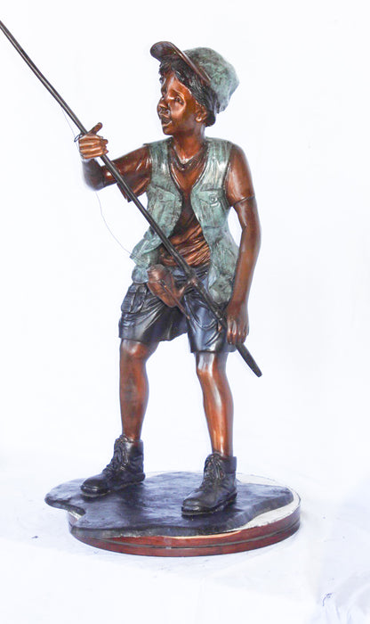 A young boy and his fishing journey bronze statue -  Size: 24"L x 26"W x 47"H.