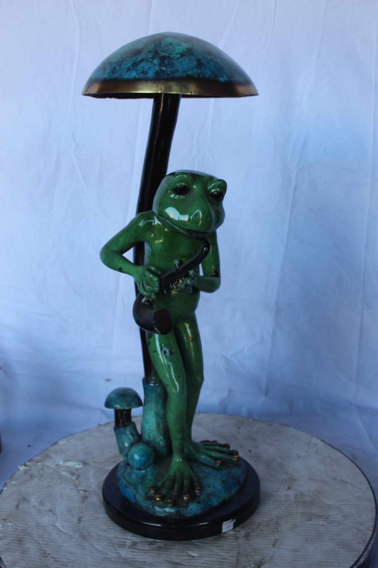 Jazzy frog perched under mushroom bronze statue   -  Size: 10"L x 10"W x 28"H.