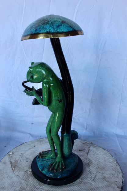 Jazzy frog perched under mushroom bronze statue   -  Size: 10"L x 10"W x 28"H.