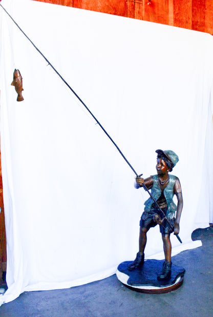 A young boy and his fishing journey bronze statue -  Size: 24"L x 26"W x 47"H.
