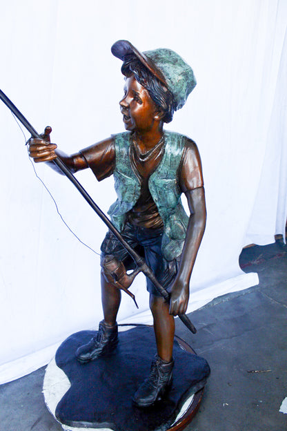 A young boy and his fishing journey bronze statue -  Size: 24"L x 26"W x 47"H.