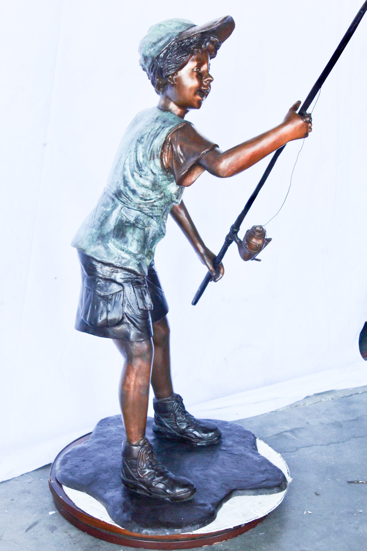 A young boy and his fishing journey bronze statue -  Size: 24"L x 26"W x 47"H.