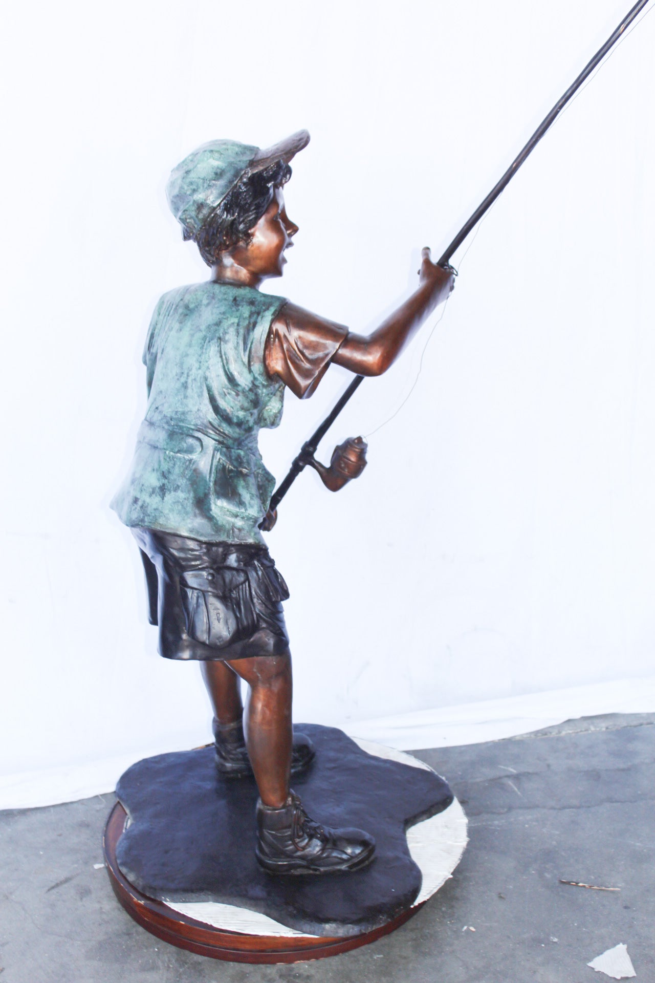 A young boy and his fishing journey bronze statue -  Size: 24"L x 26"W x 47"H.