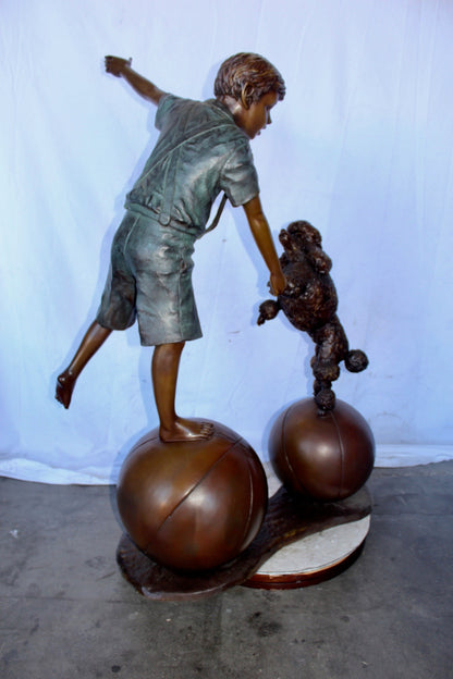 Boy and poodle balancing circus stars bronze statue -  Size: 38" x 27" x 55"H.