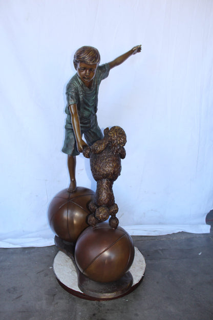 Boy and poodle balancing circus stars bronze statue -  Size: 38" x 27" x 55"H.