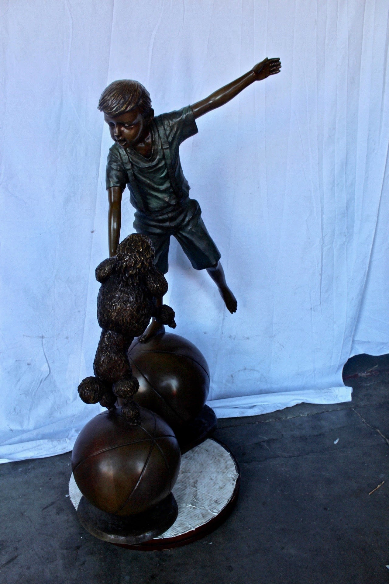 Boy and poodle balancing circus stars bronze statue -  Size: 38" x 27" x 55"H.