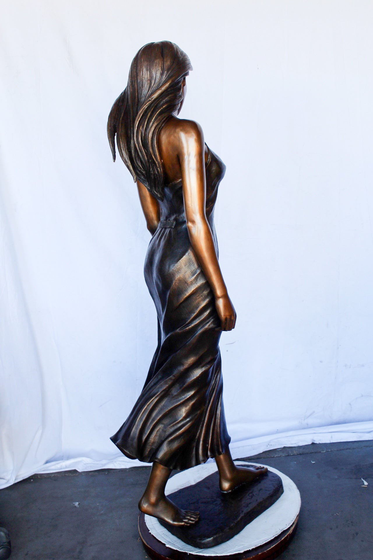 Peaceful woman in dress bronze statue -  Size: 17"L x 25"W x 67"H.