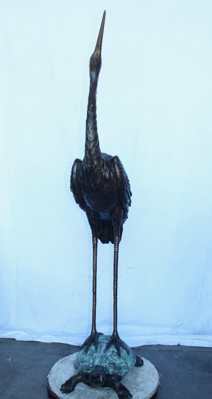Blue Heron looking up on turtle bronze statue fountain  Size: 21" x 16" x 71"H.