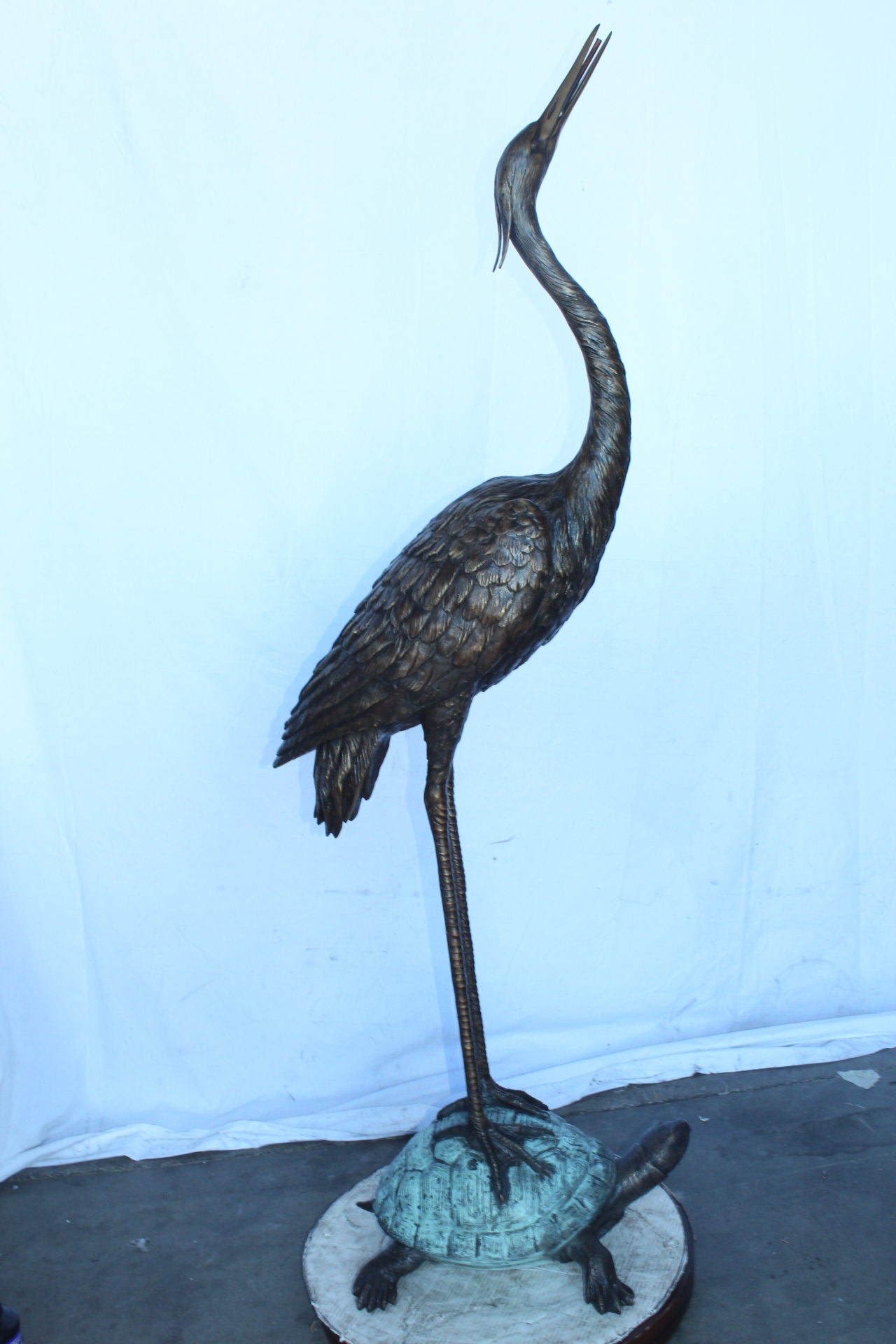 Blue Heron looking up on turtle bronze statue fountain  Size: 21" x 16" x 71"H.