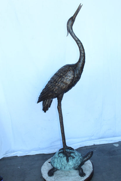 Blue Heron looking up on turtle bronze statue fountain  Size: 21" x 16" x 71"H.
