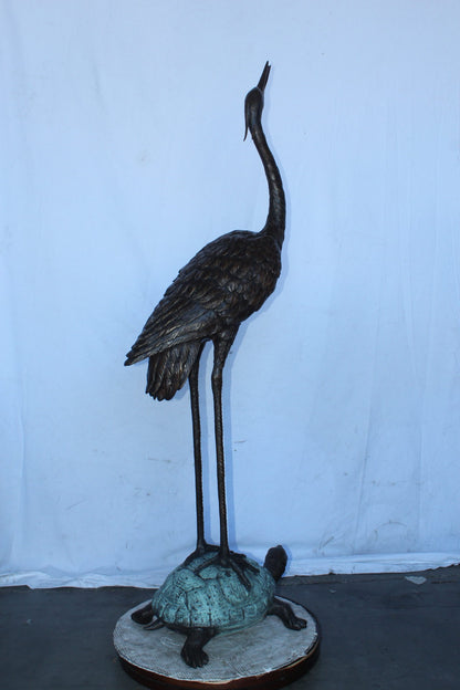 Blue Heron looking up on turtle bronze statue fountain  Size: 21" x 16" x 71"H.