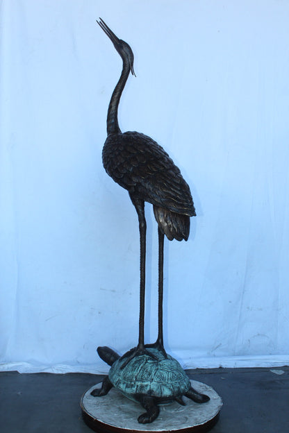 Blue Heron looking up on turtle bronze statue fountain  Size: 21" x 16" x 71"H.