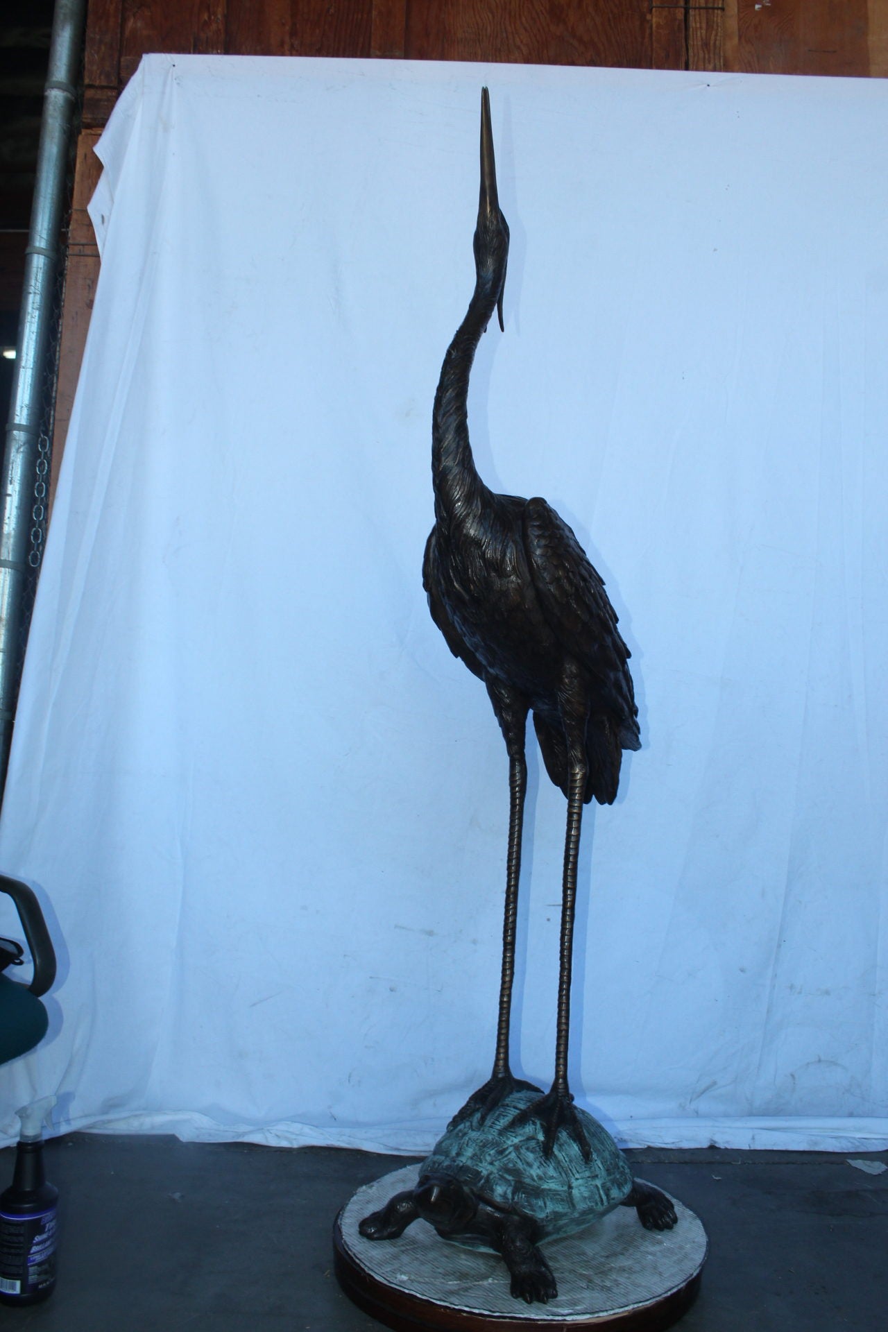 Blue Heron looking up on turtle bronze statue fountain  Size: 21" x 16" x 71"H.