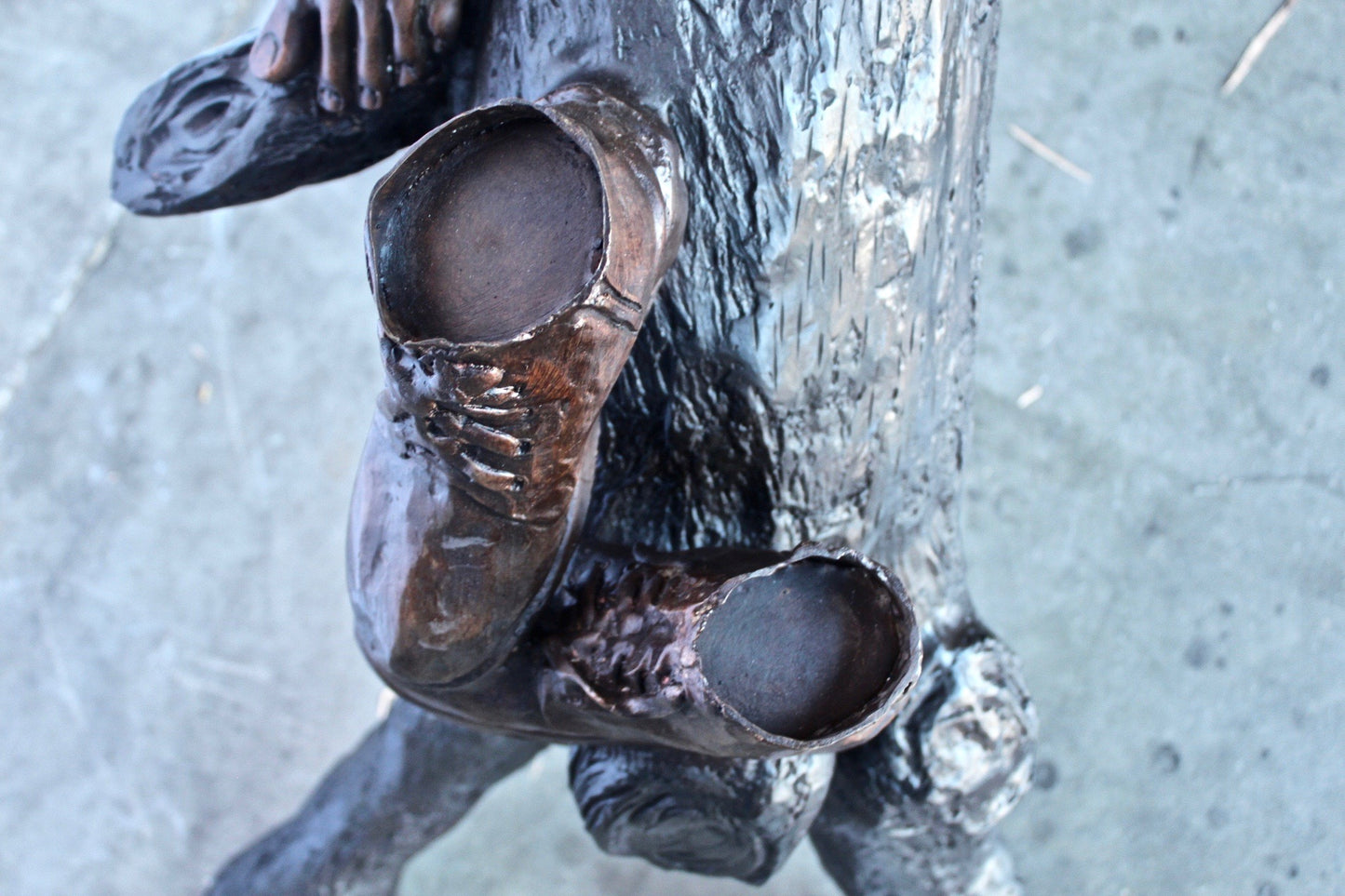 Boy and girl reading on arched tree bronze statue  -  Size: 70"L x 29"W x 56"H.