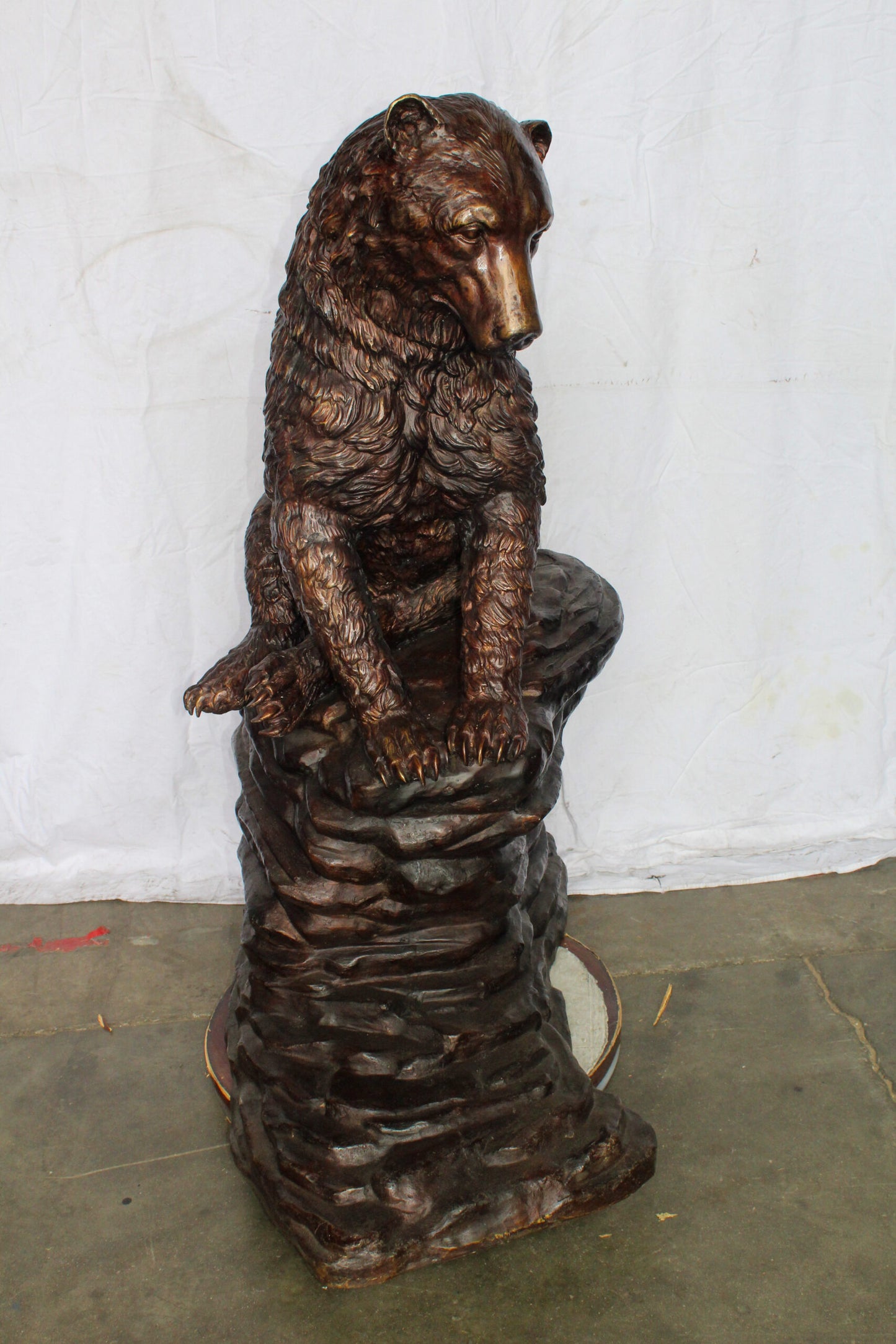 Life Size Bronze Statue of a Bear Sitting on A Rock 43" x 29" x 51"H