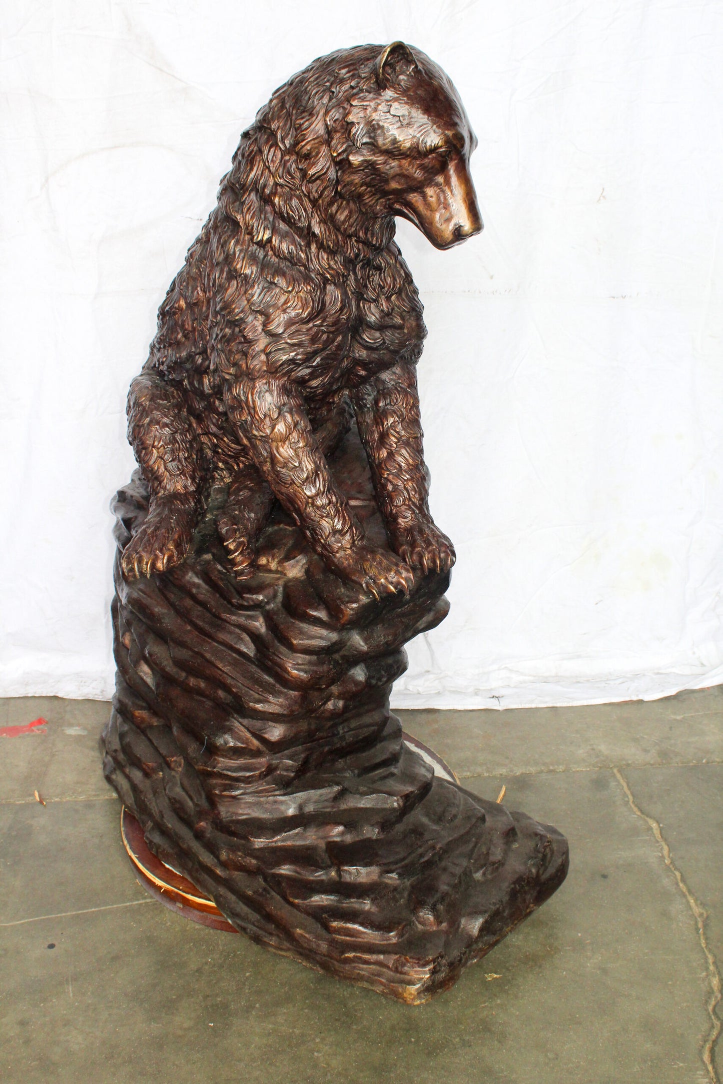 Life Size Bronze Statue of a Bear Sitting on A Rock 43" x 29" x 51"H