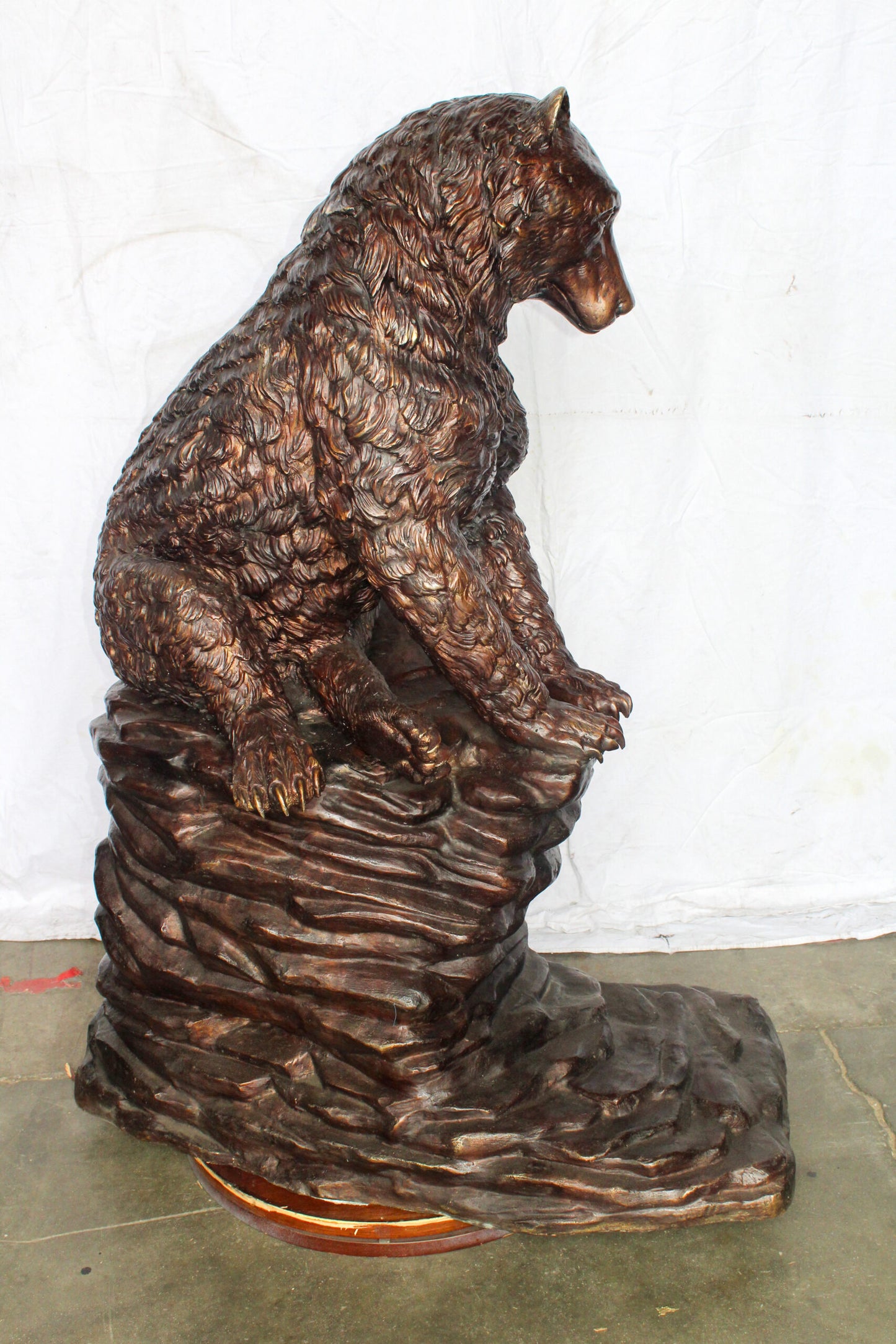 Life Size Bronze Statue of a Bear Sitting on A Rock 43" x 29" x 51"H