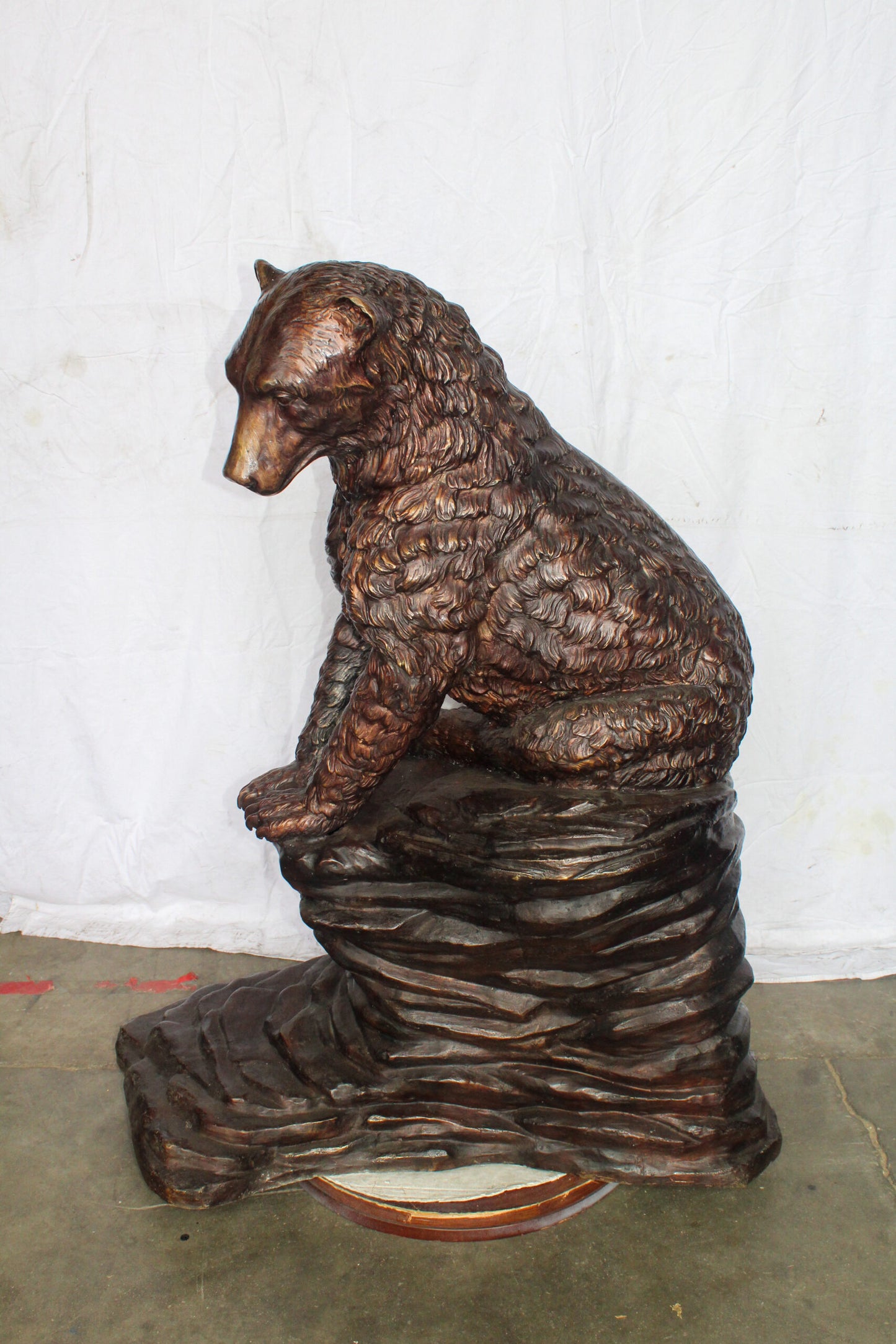 Life Size Bronze Statue of a Bear Sitting on A Rock 43" x 29" x 51"H