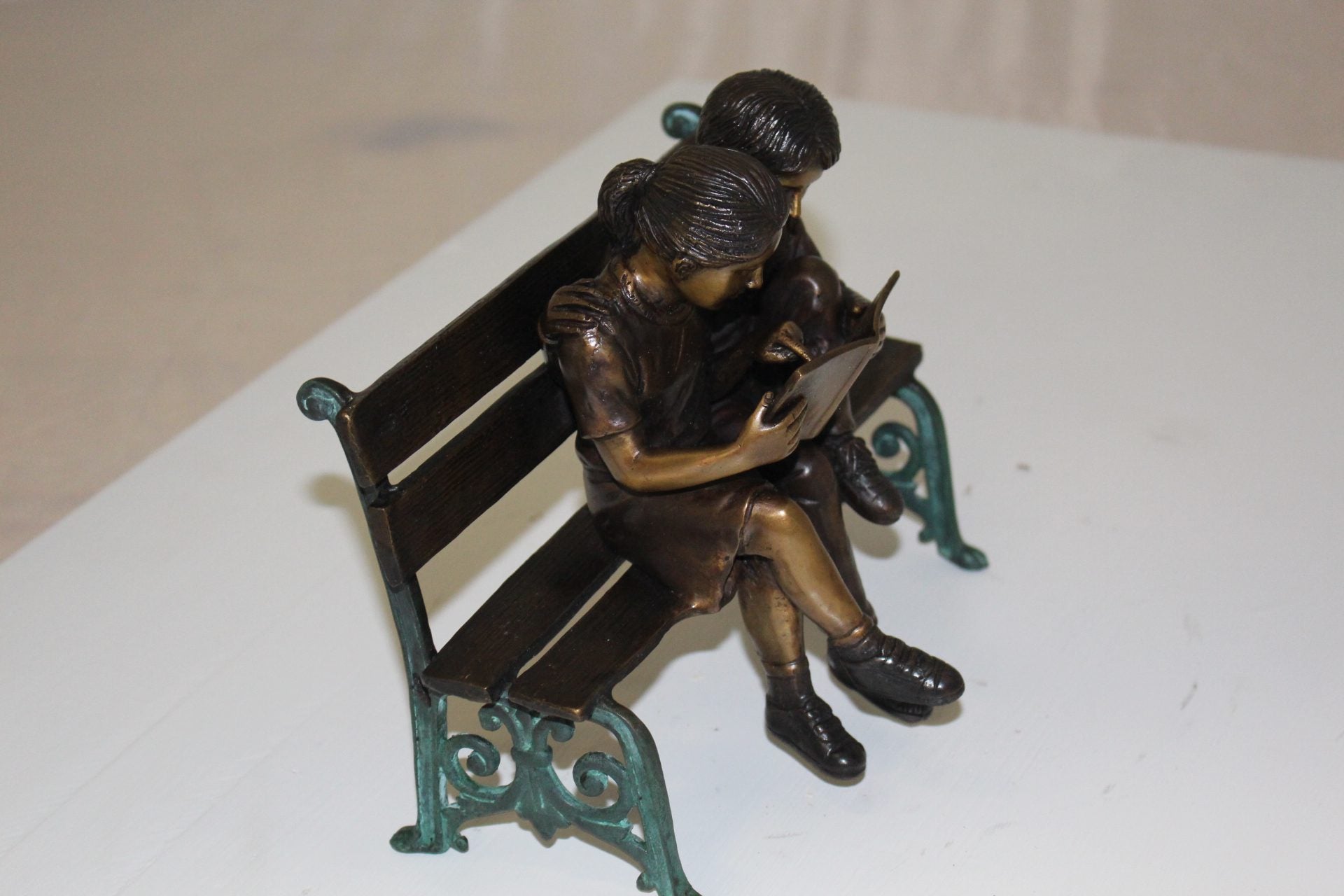 Two kids on bench reading a book - Bronze Statue -  Size: 9"L x 6"W x 8"H. 