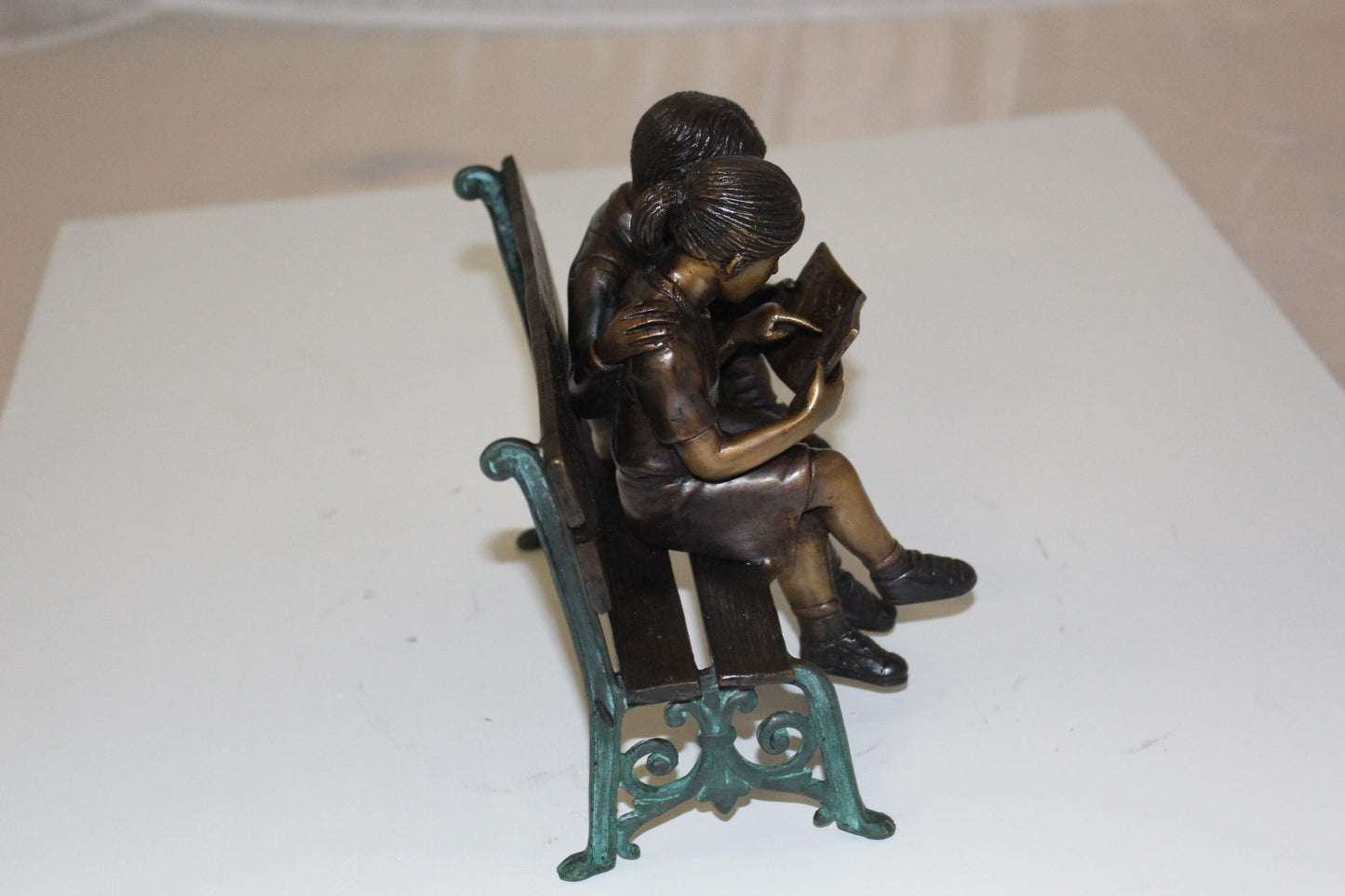 Two kids on bench reading a book - Bronze Statue -  Size: 9"L x 6"W x 8"H. 