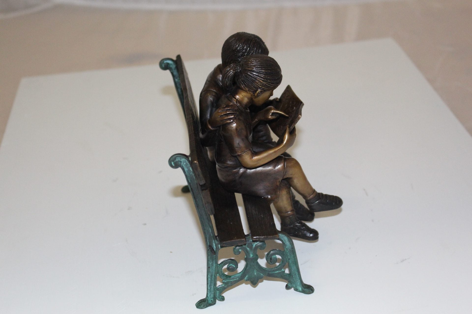 Two kids on bench reading a book - Bronze Statue -  Size: 9"L x 6"W x 8"H. 