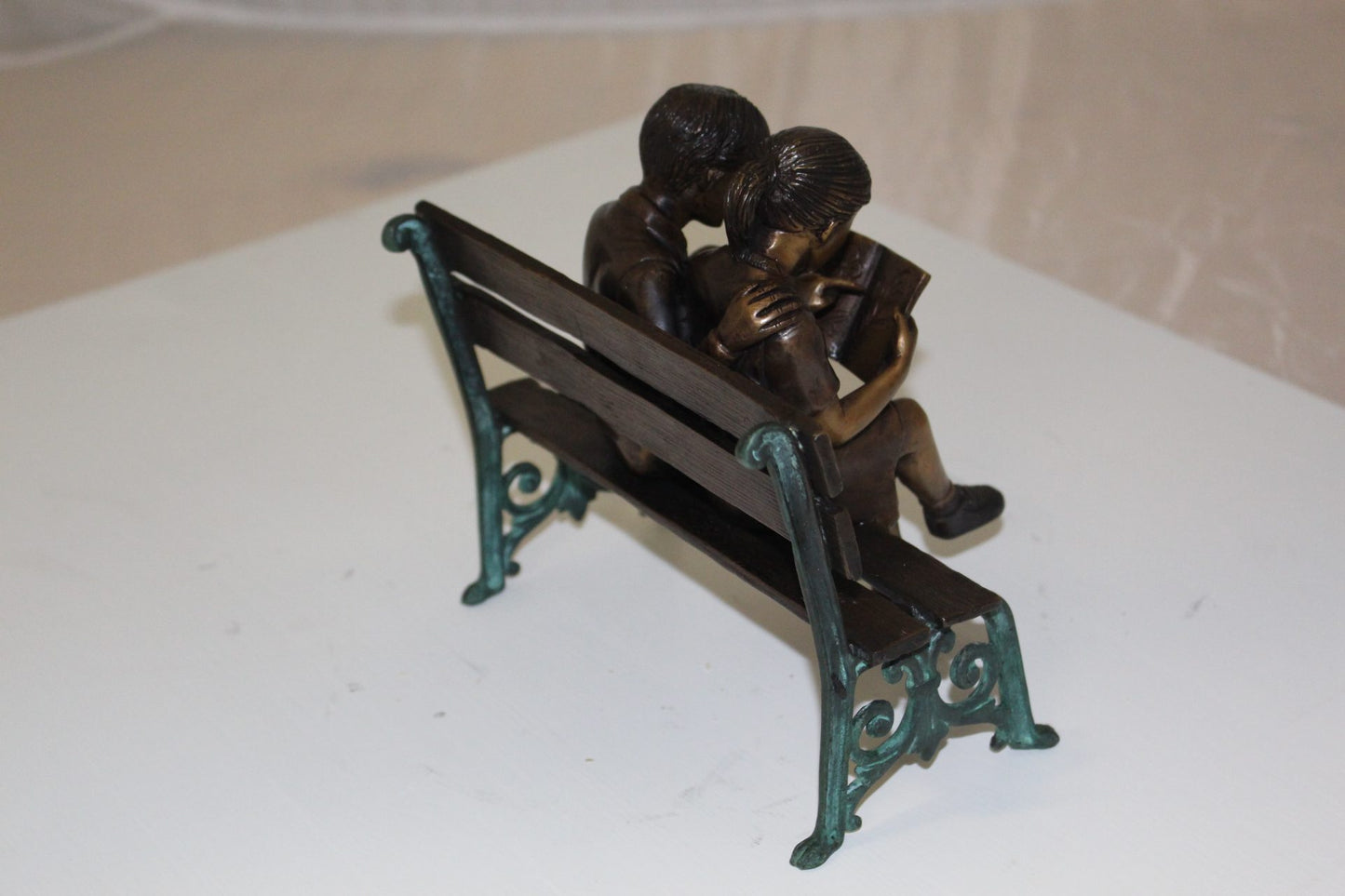 Two kids on bench reading a book - Bronze Statue -  Size: 9"L x 6"W x 8"H. 