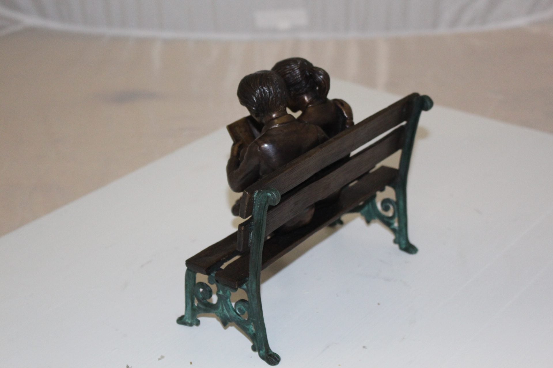 Two kids on bench reading a book - Bronze Statue -  Size: 9"L x 6"W x 8"H. 