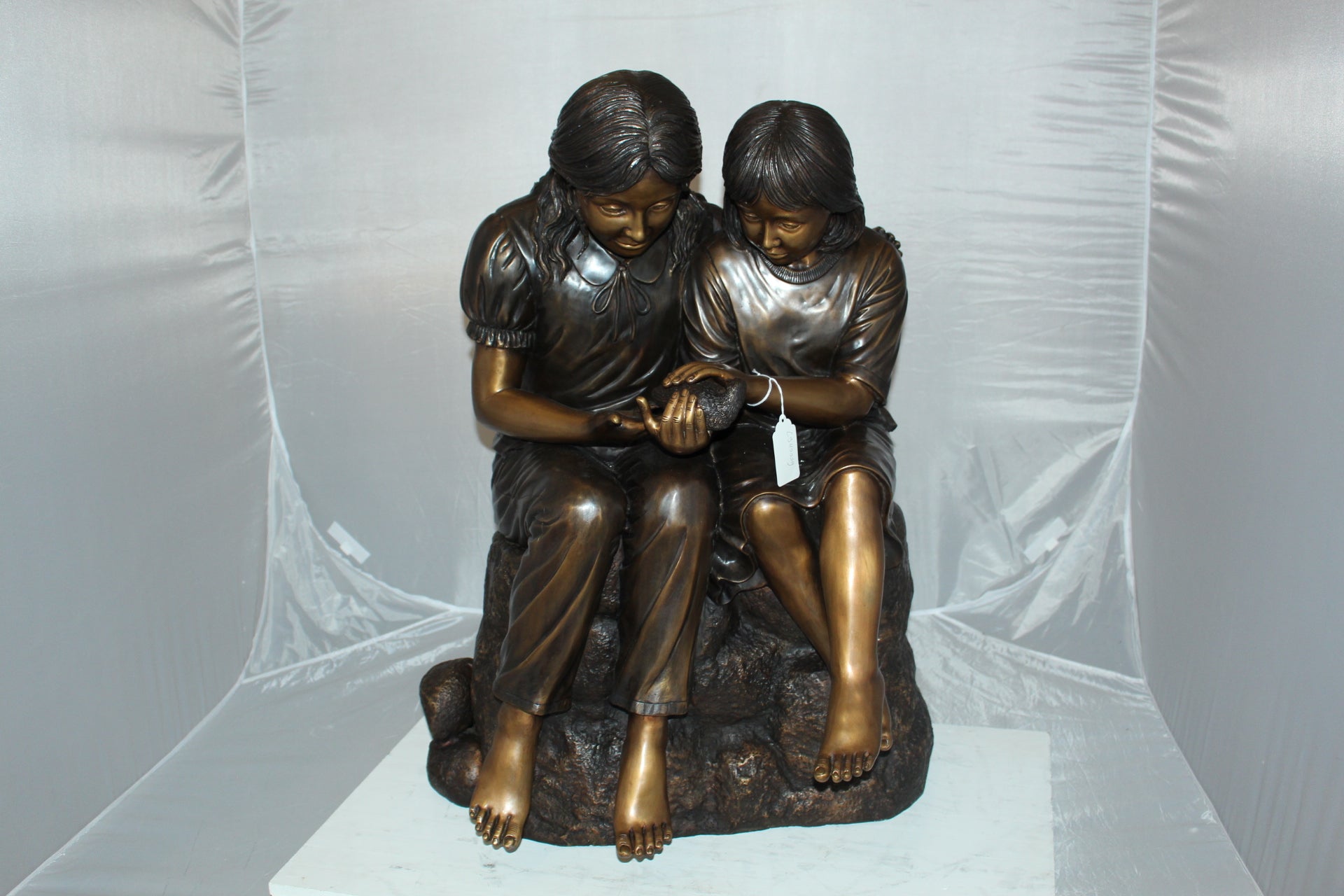 Two kids holding a bird Bronze Statue -  Size: 18"L x 26"W x 34"H. 