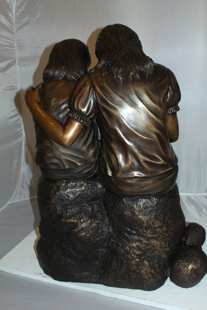 Two kids holding a bird Bronze Statue -  Size: 18"L x 26"W x 34"H. 
