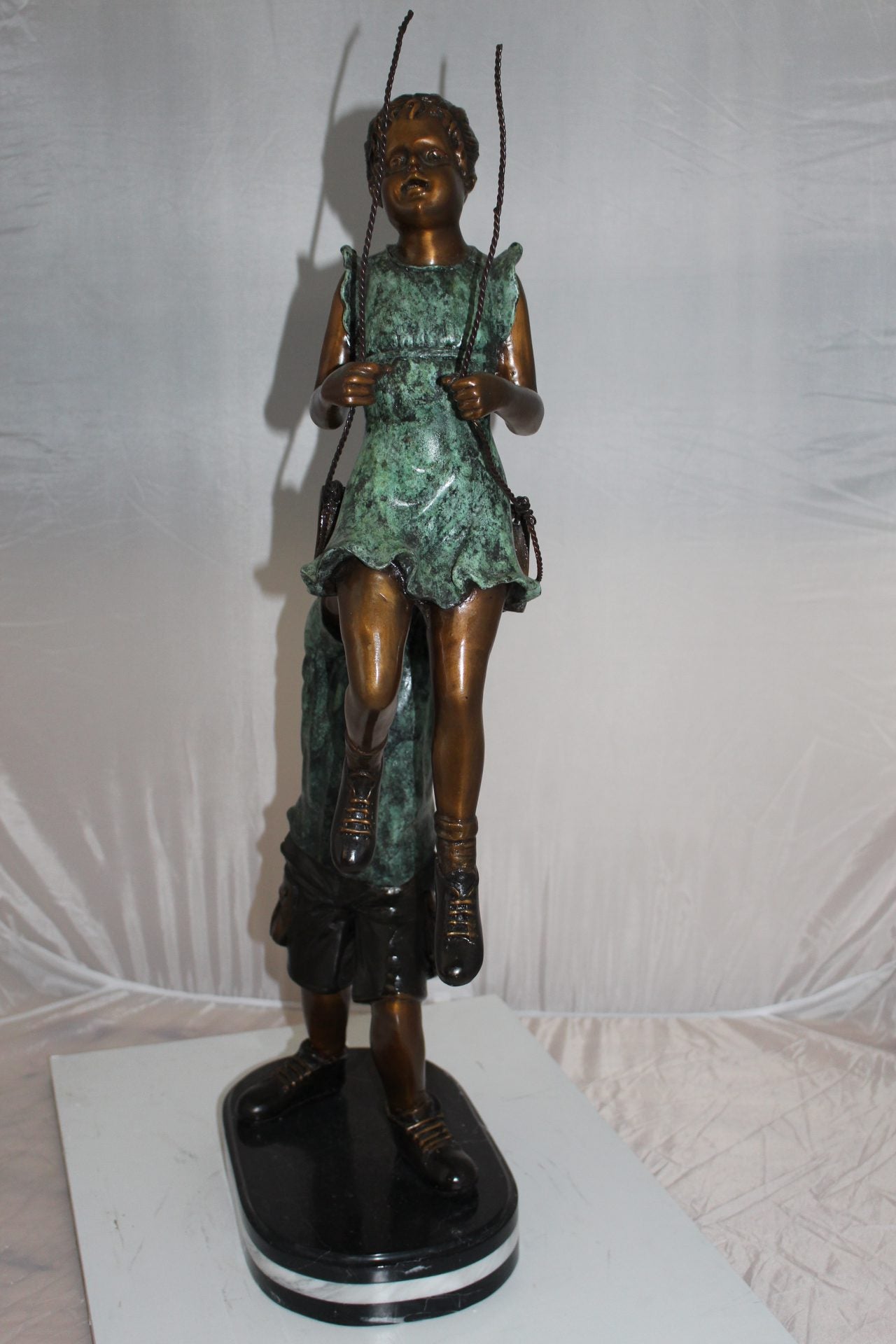 Children-on-swing-Bronze-Statue -  Size: 20"L x 9"W x 39"H. 