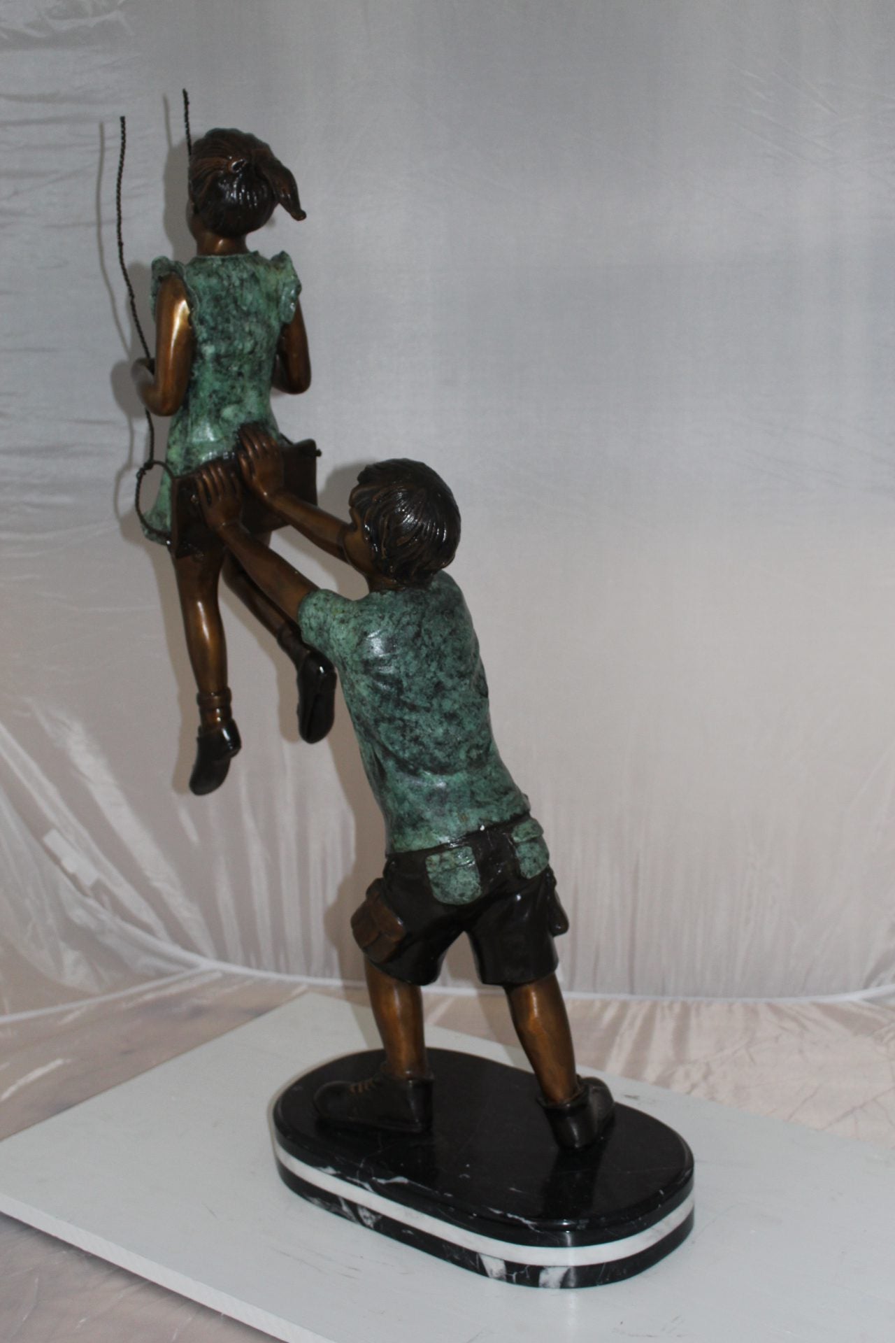 Children-on-swing-Bronze-Statue -  Size: 20"L x 9"W x 39"H. 