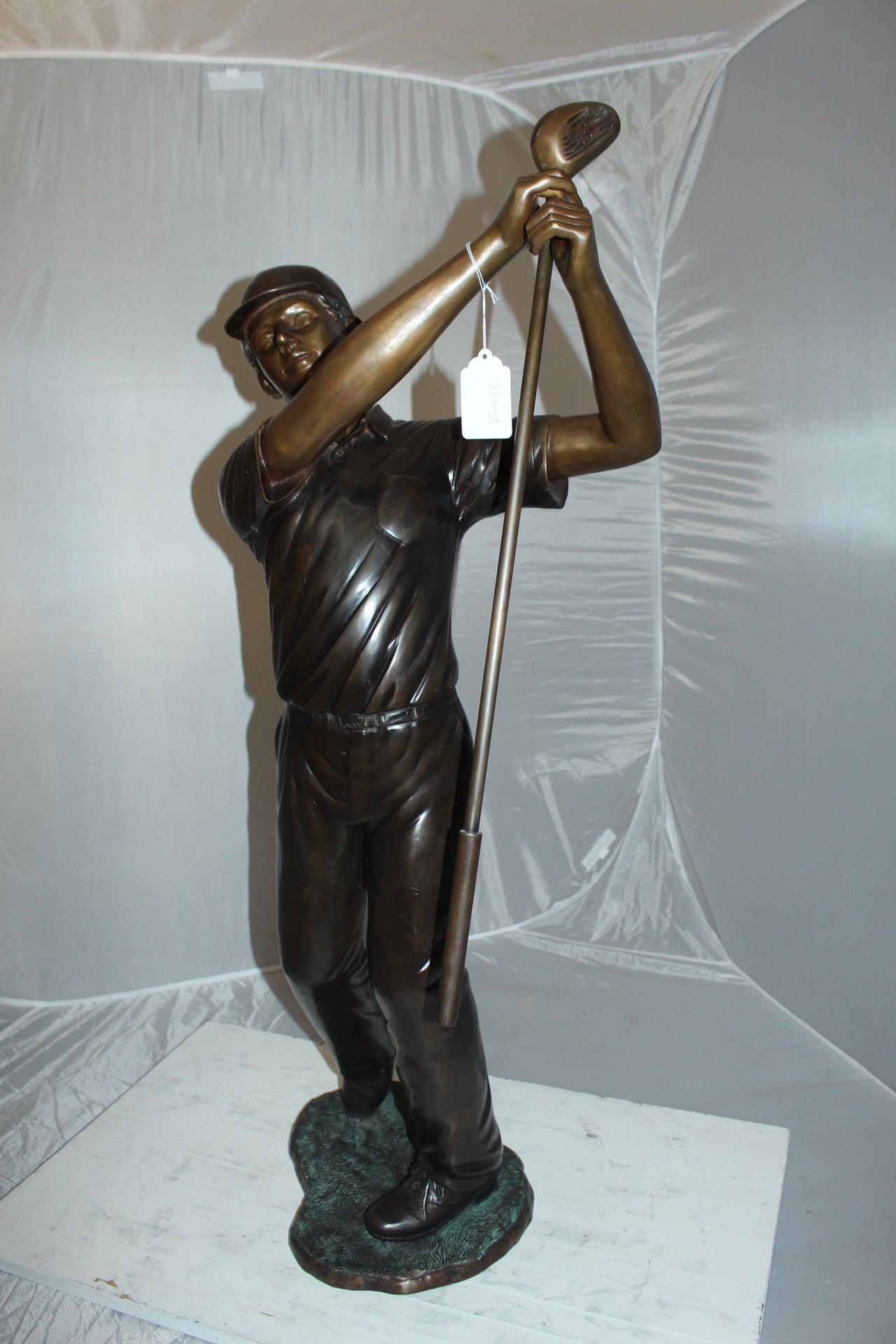 Teen boy plays golf Bronze Statue -  Size: 18"L x 13"W x 57"H. 