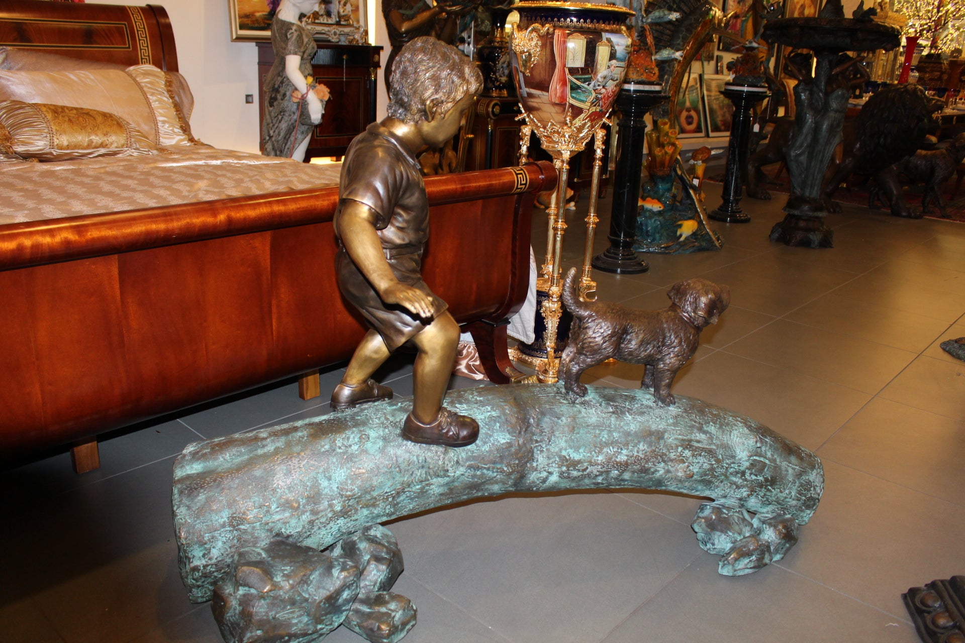 Kid with dog walking on a log Bronze Statue -  Size: 57"L x 18"W x 41"H. 