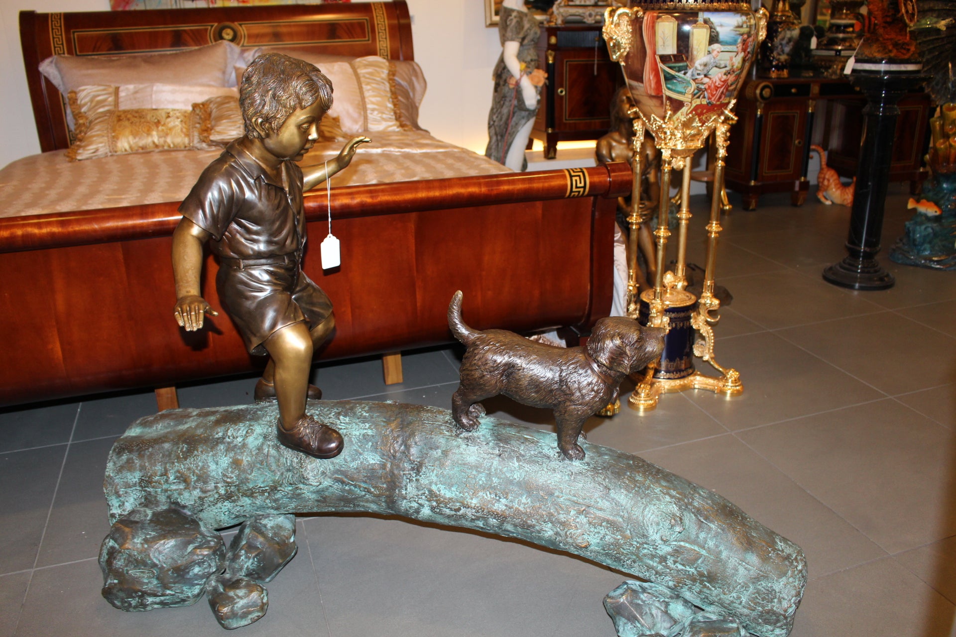 Kid with dog walking on a log Bronze Statue -  Size: 57"L x 18"W x 41"H. 