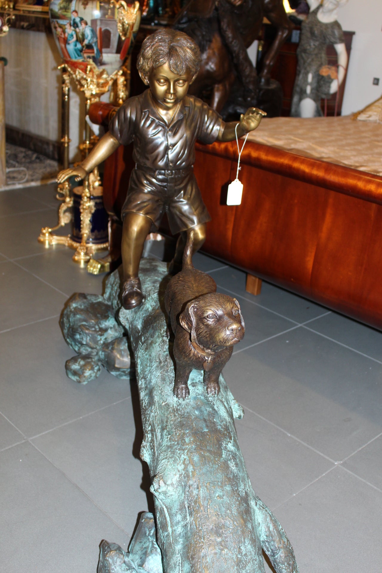 Kid with dog walking on a log Bronze Statue -  Size: 57"L x 18"W x 41"H. 