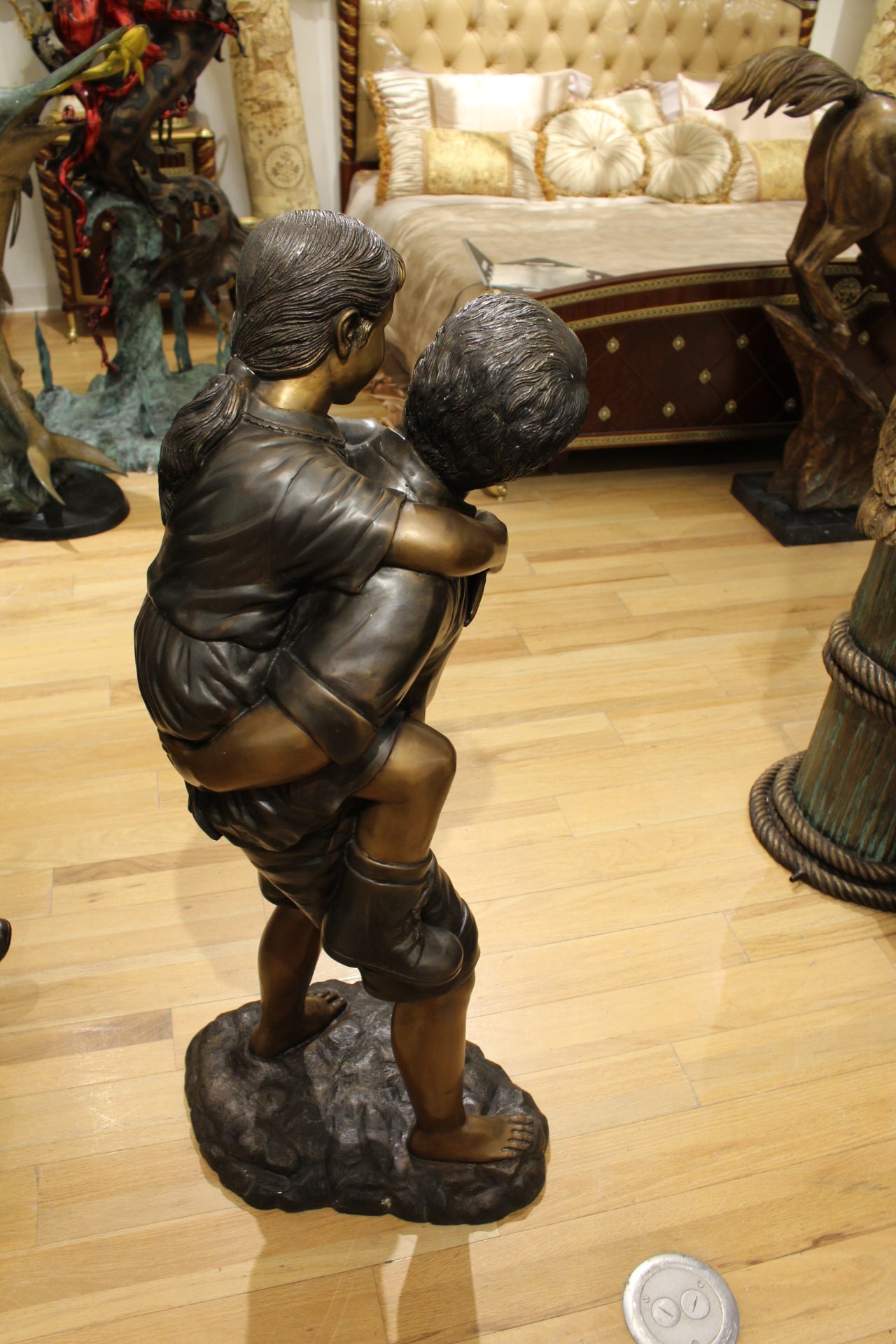 Boy Giving Girl Piggyback Ride Bronze Statue -  Size: 23"L x 16"W x 46"H. 