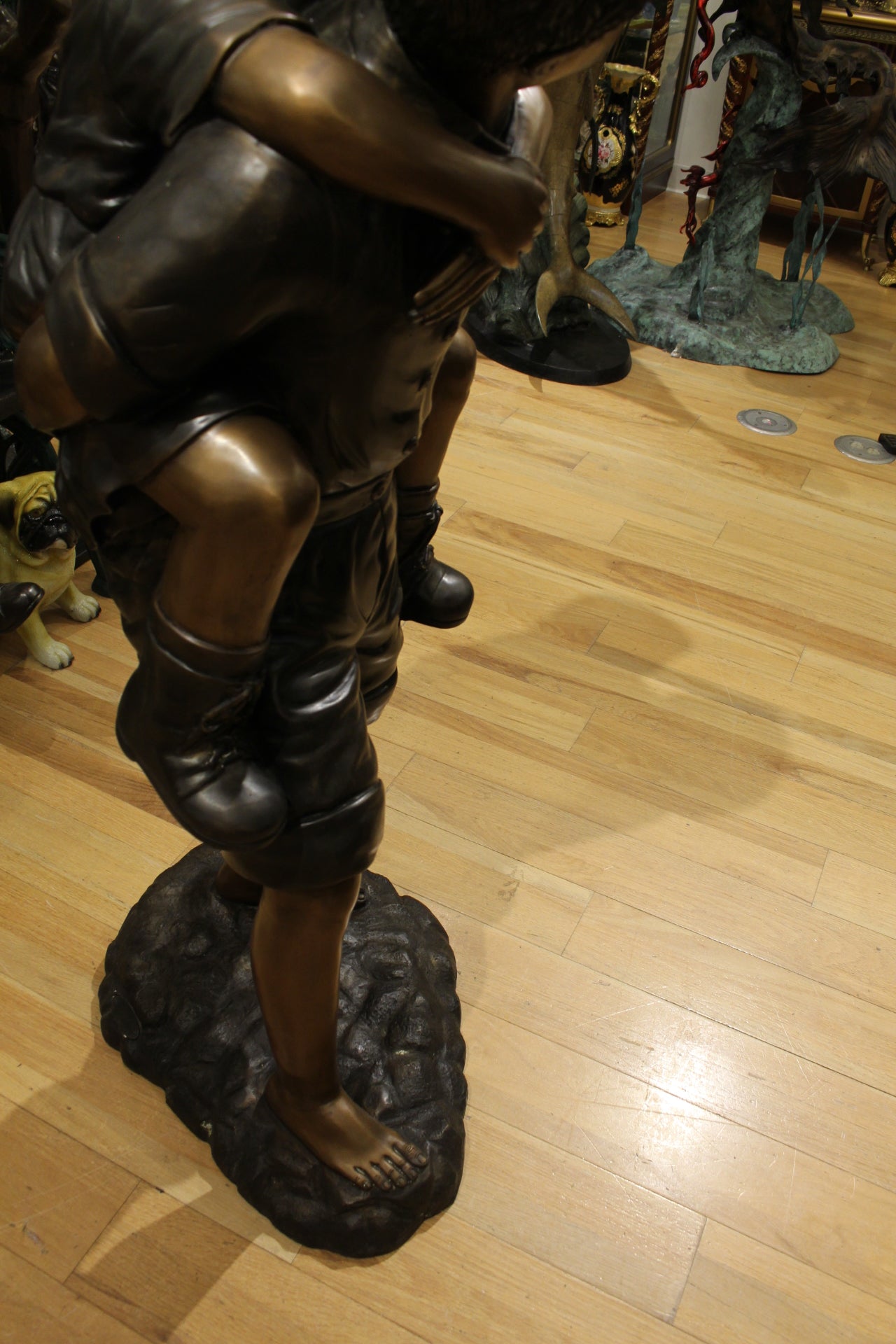 Boy Giving Girl Piggyback Ride Bronze Statue -  Size: 23"L x 16"W x 46"H. 