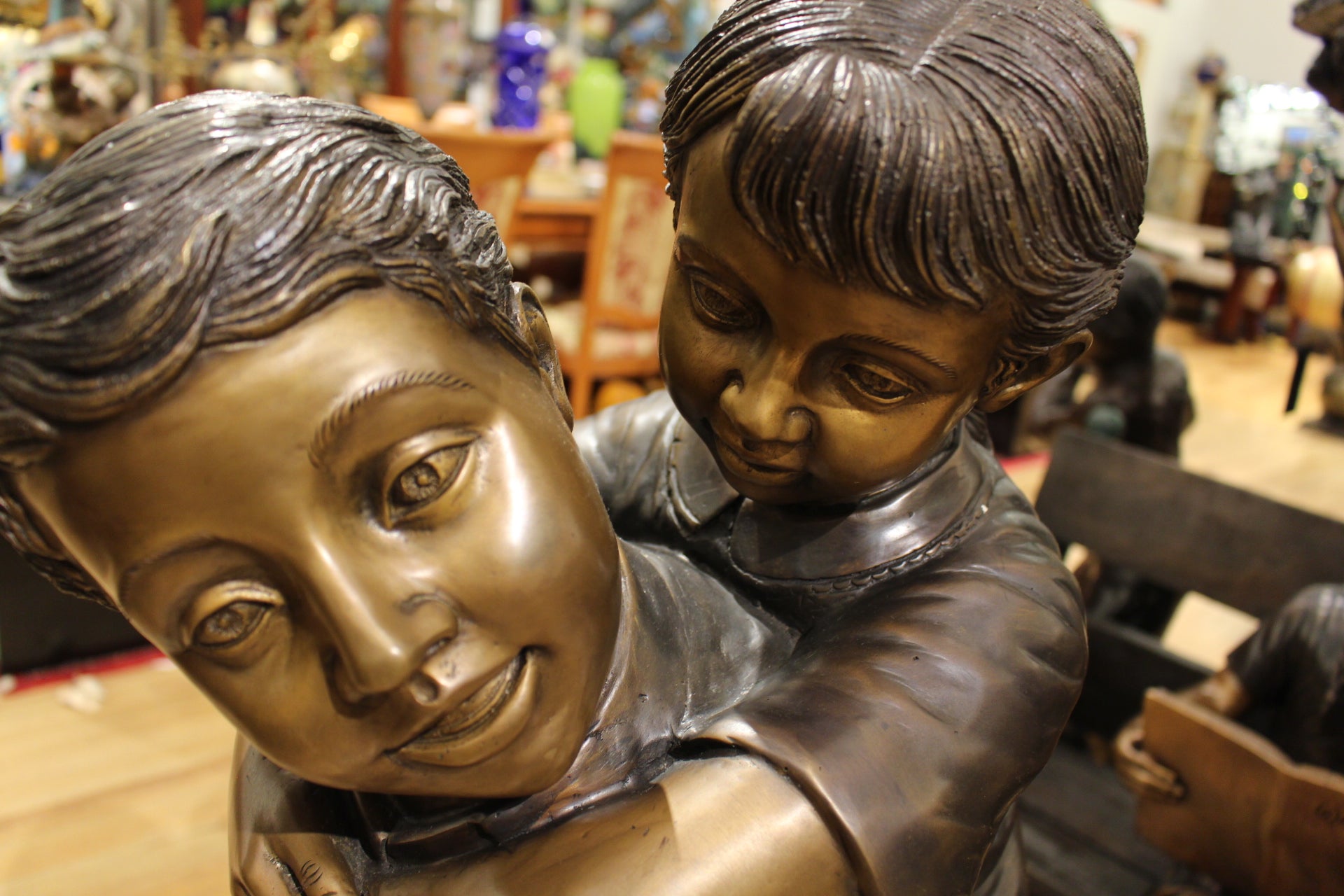 Boy Giving Girl Piggyback Ride Bronze Statue -  Size: 23"L x 16"W x 46"H. 