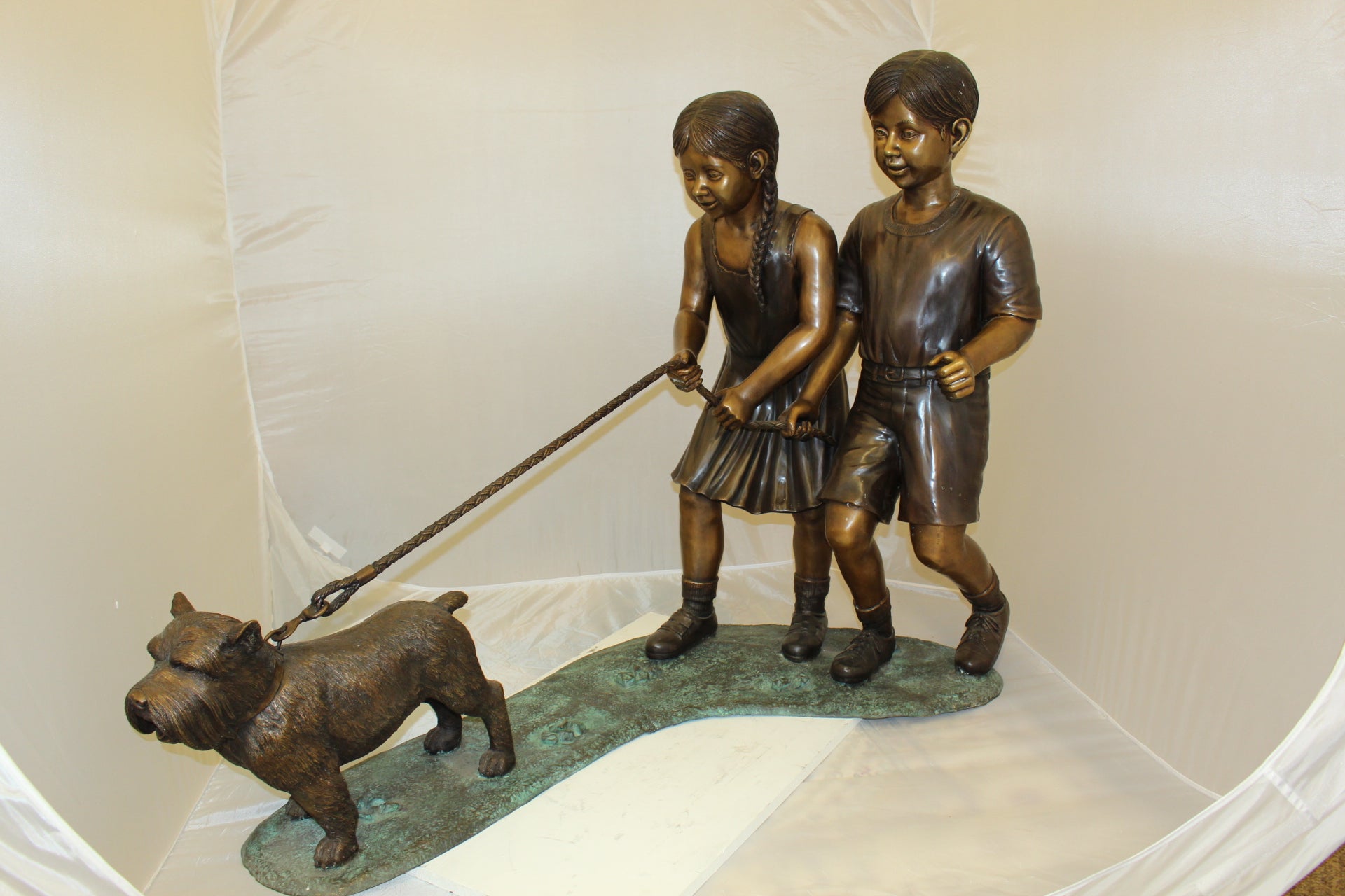 Two Kids Walking a dog Bronze Statue -  Size: 55"L x 28"W x 37"H. 