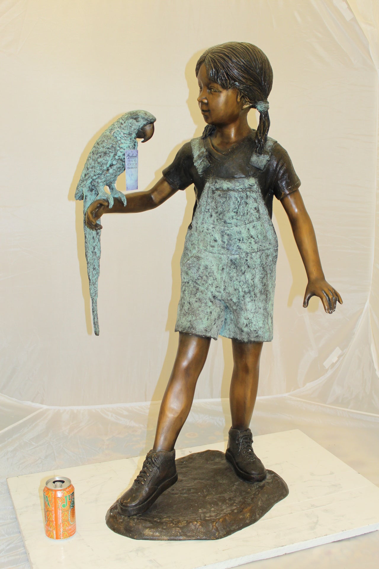 Girl Holding a Parrot Bronze Statue -  Size: 26"L x 19"W x 42"H. 