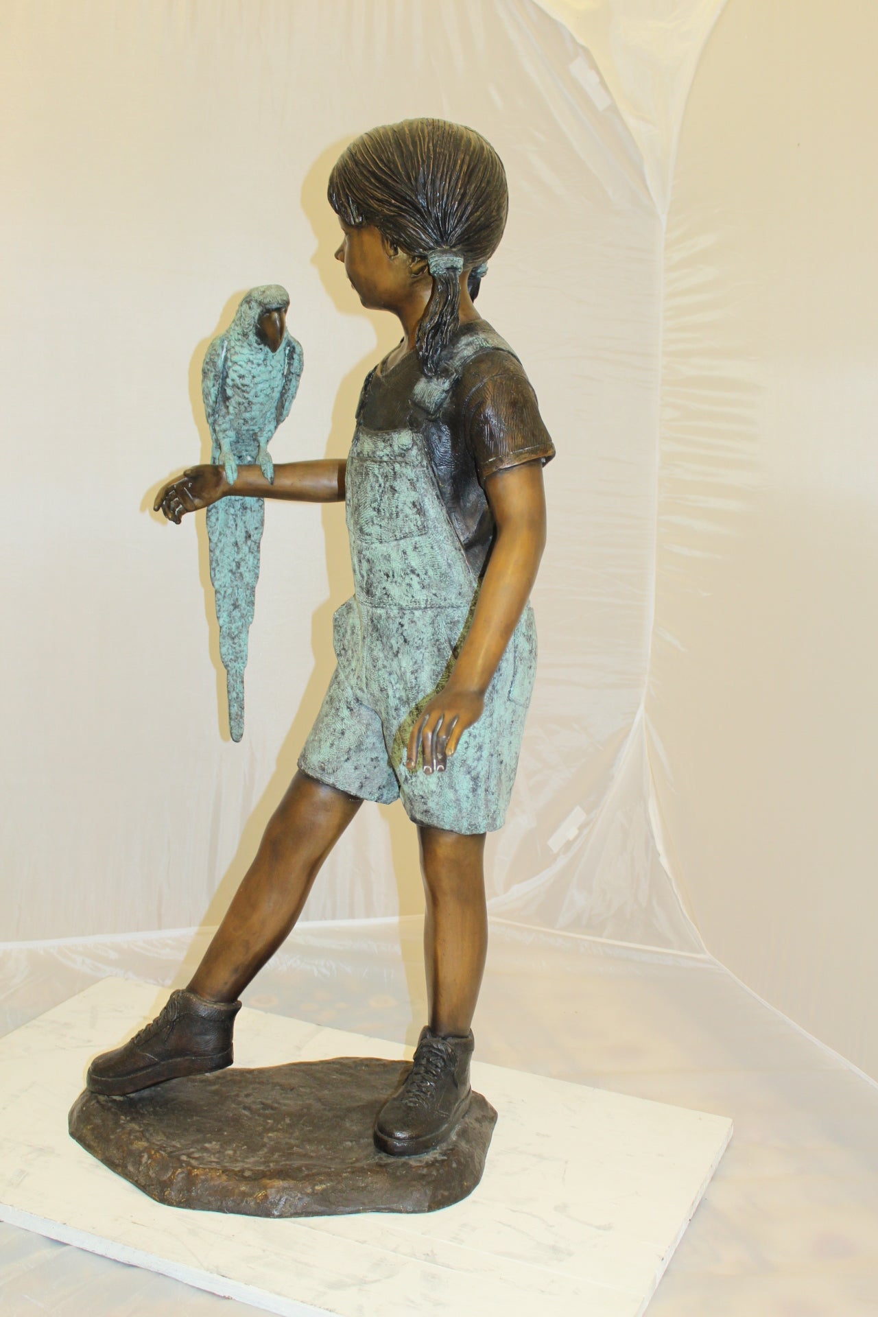 Girl Holding a Parrot Bronze Statue -  Size: 26"L x 19"W x 42"H. 