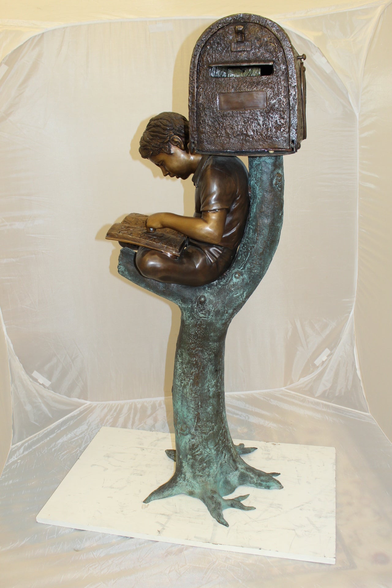 Boy Sitting by a Mailbox reading a book Bronze Statue -  16"L x 20"W x 50"H. 