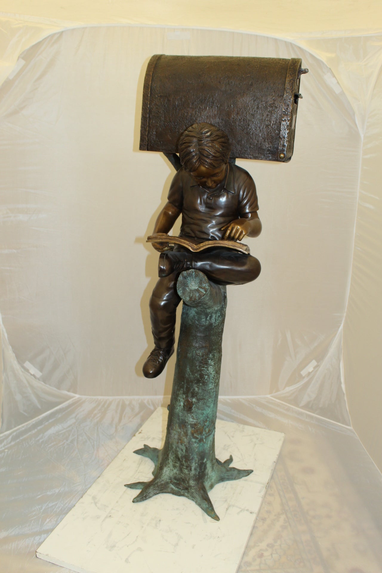 Boy Sitting by a Mailbox reading a book Bronze Statue -  16"L x 20"W x 50"H. 