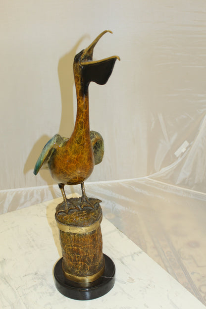 Pelican on a Tree Stump Bronze Statue -  Size: 8"L x 12"W x 27"H. 