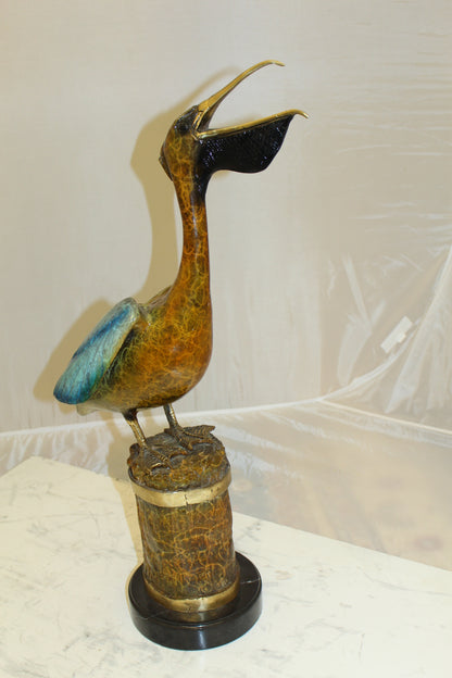 Pelican on a Tree Stump Bronze Statue -  Size: 8"L x 12"W x 27"H. 