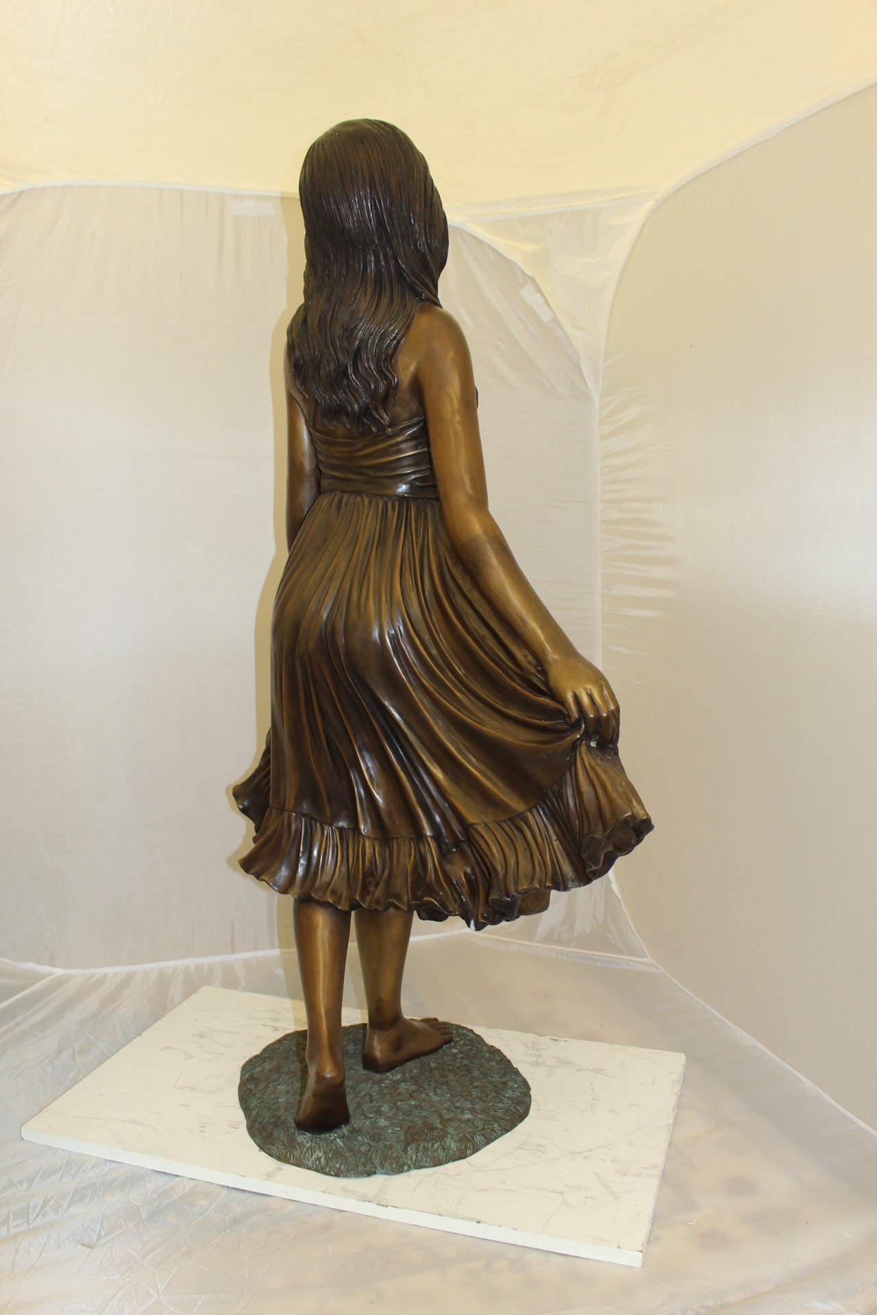 Lady holding her Skirt Bronze Statue -  Size: 32"L x 17"W x 53"H. 